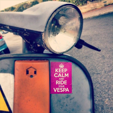 Scooter with the sticker on the front "Keep Calm and Vespa"
